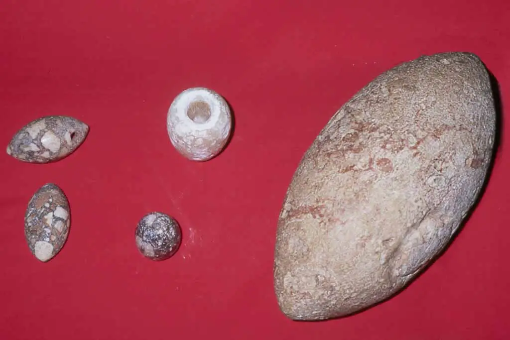The large stone is of exotic material and may have had ceremonial use. Photos by J. Flores courtesy of the Guam Museum, 1998.
