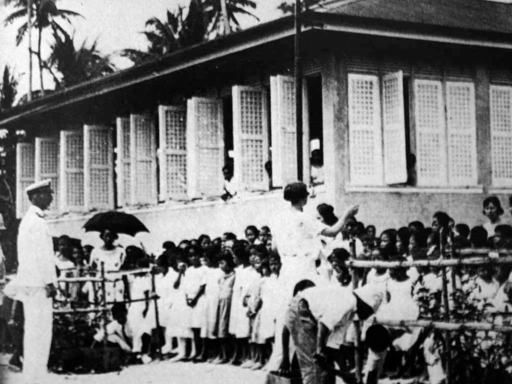 Naval Governor Henry B. Price observes the students of Sumay school. Don Farrell collection.