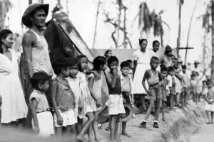 Survivors line the streets to greet Admirals Nimitz and Spruance.