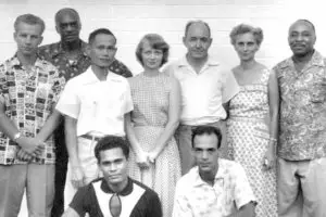 The first Local Spiritual Assembly in the Marianas. At rear, left is Robert Powers. At front left is Joe Ilengelkei. Edgar and Cynthia Olson are in the back row.