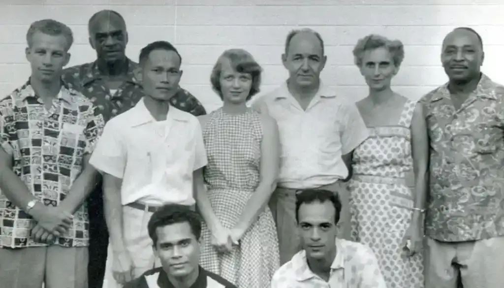 The first Local Spiritual Assembly in the Marianas. At rear, left is Robert Powers. At front left is Joe Ilengelkei. Edgar and Cynthia Olson are in the back row.