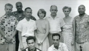 The first Local Spiritual Assembly in the Marianas. At rear, left is Robert Powers. At front left is Joe Ilengelkei. Edgar and Cynthia Olson are in the back row.