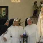 The Dominican sisters admire a new statue of Mary. Archdiocese of Agaña