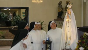 The Dominican sisters admire a new statue of Mary. Archdiocese of Agaña