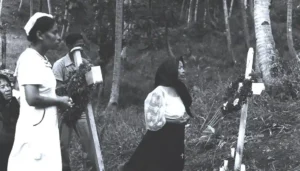 Men and women gather to honor family members lost in the massacres. Micronesian Area Research Center (MARC) collection.