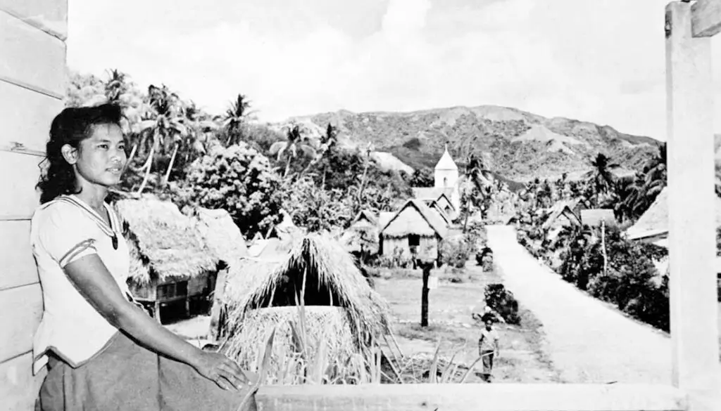 Young Chamorro lady and pre-war Humåtak village scene. Guam Museum collection.