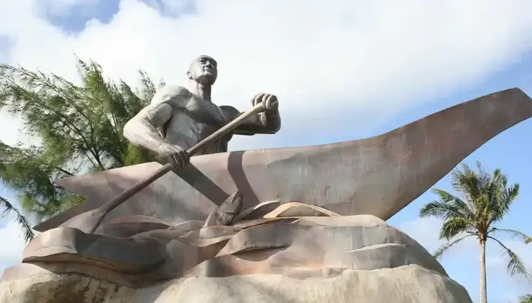 Legendary Chief Gadao paddles his half of a canoe to Inalåhan/Inarajan after outsmarting a Tumon chief in a contest of strength.