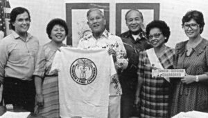 Governor Ricardo Bordallo proudly receives a t-shirt from the Chamorro (CHamoru) Language Commission.
