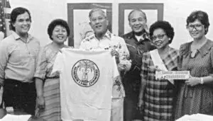 Governor Ricardo Bordallo proudly receives a t-shirt from the Chamorro (CHamoru) Language Commission.