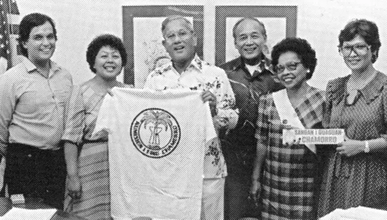 Governor Ricardo Bordallo proudly receives a t-shirt from the Chamorro (CHamoru) Language Commission.