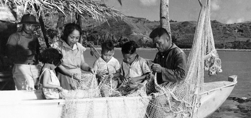 Family mending their talaya. Photo from the Micronesian Area Research Center (MARC) courtesy of Dr. Anne Hattori.