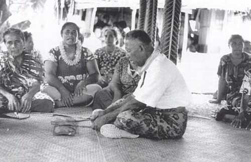 The papa (sounding board) being played for singers in Nukunonu, Tokelau (1967). Photo by Judith Huntsman.