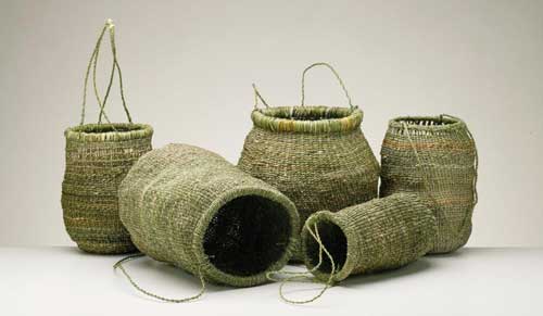 Contemporary Tasmanian Aboriginal baskets. Left to right: Vicki maikutena Green, Patsy Cameron (also second from right), Dulcie Greeno, Audrey Frost. Image courtesy of the Tasmanian Museum and Art Gallery
