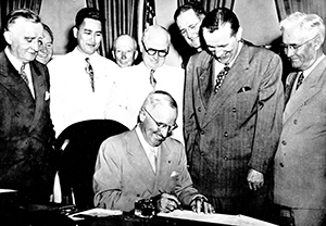Pres. Truman signs the Guam Organic Act, 1950. MARC collection Organic Act