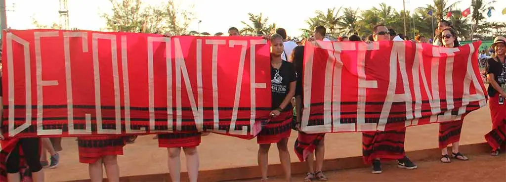 Fanohge CHamoru Exhibition Section 2: Unpacking Terms. Decolonize Oceania. From the 12th Festival of Pacific Arts and Culture closing ceremony, Guam, 2016. Photo by Ron Castro.