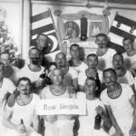 Crew members of the SMS Cormoran gather for a group photo during their New Years party, 1915. Photo from SMS Cormoran album at Manuscripts Collection RFT MARC, University of Guam.