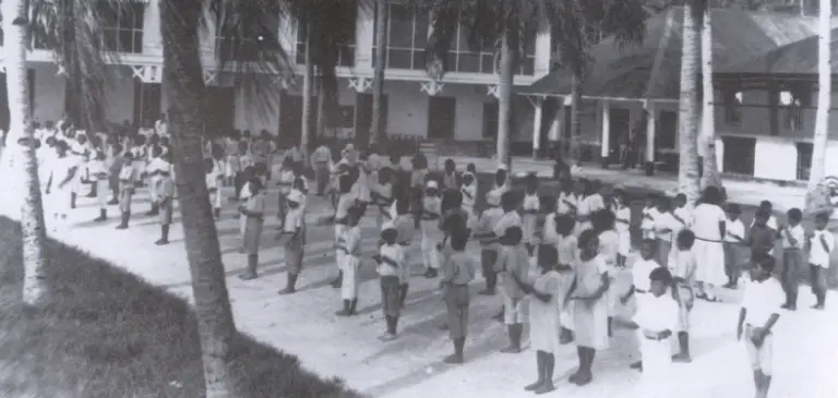 Schoolchildren lined up for a fingernail and cleanliness inspection
